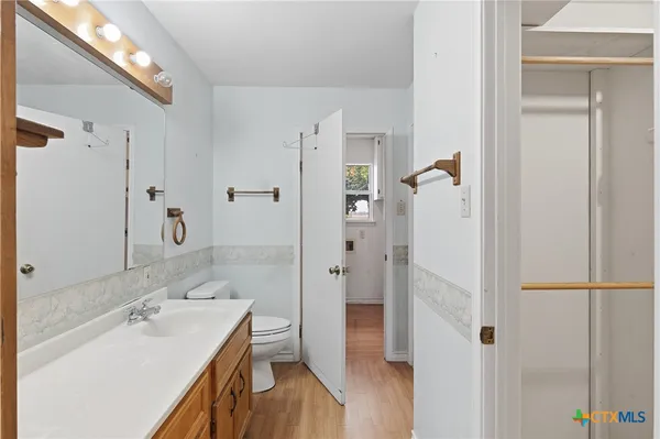 a bathroom with a sink and a mirror with shower