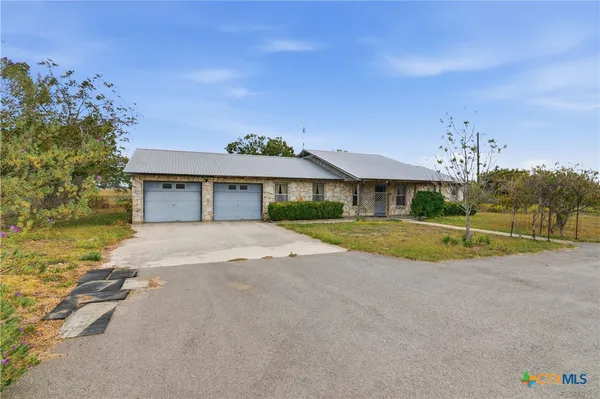 a view of a house with a yard and sitting area