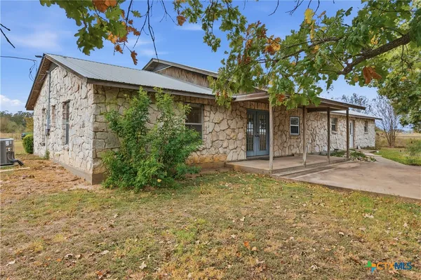 a view of a house with a tree in a yard