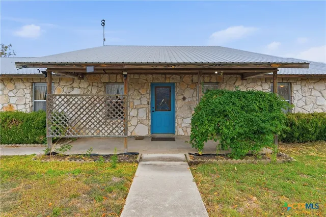 a large kitchen with stainless steel appliances wooden floor and a refrigerator