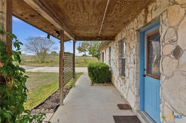 a view of a porch with wooden floor