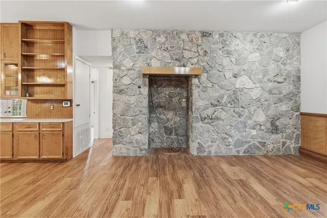 a kitchen with a sink stove top oven and cabinets
