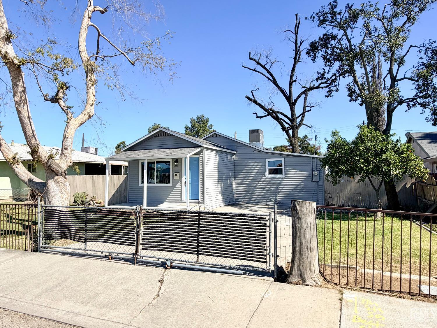 Undisclosed Address Wasco, CA 93280 - Photo 1 of 21 a house with a trees in the background