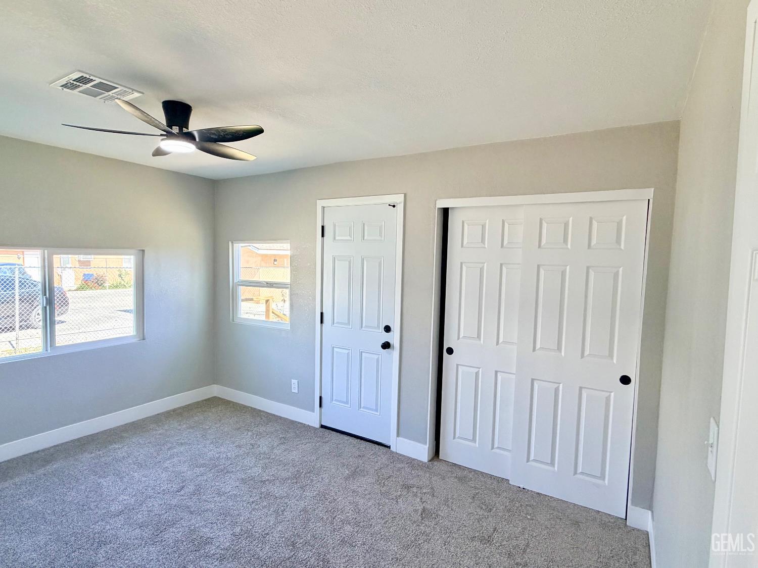 Undisclosed Address Wasco, CA 93280 - Photo 12 of 21 an empty room with windows and fan