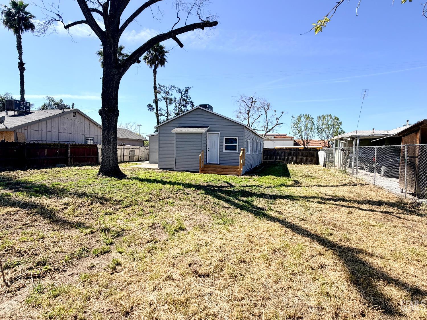 Undisclosed Address Wasco, CA 93280 - Photo 17 of 21 a view of a house with a yard