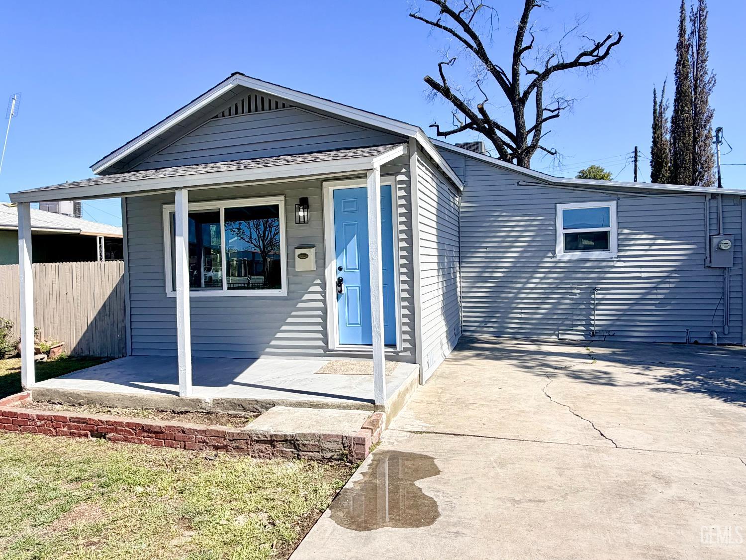 Undisclosed Address Wasco, CA 93280 - Photo 2 of 21 a front view of a house with garden