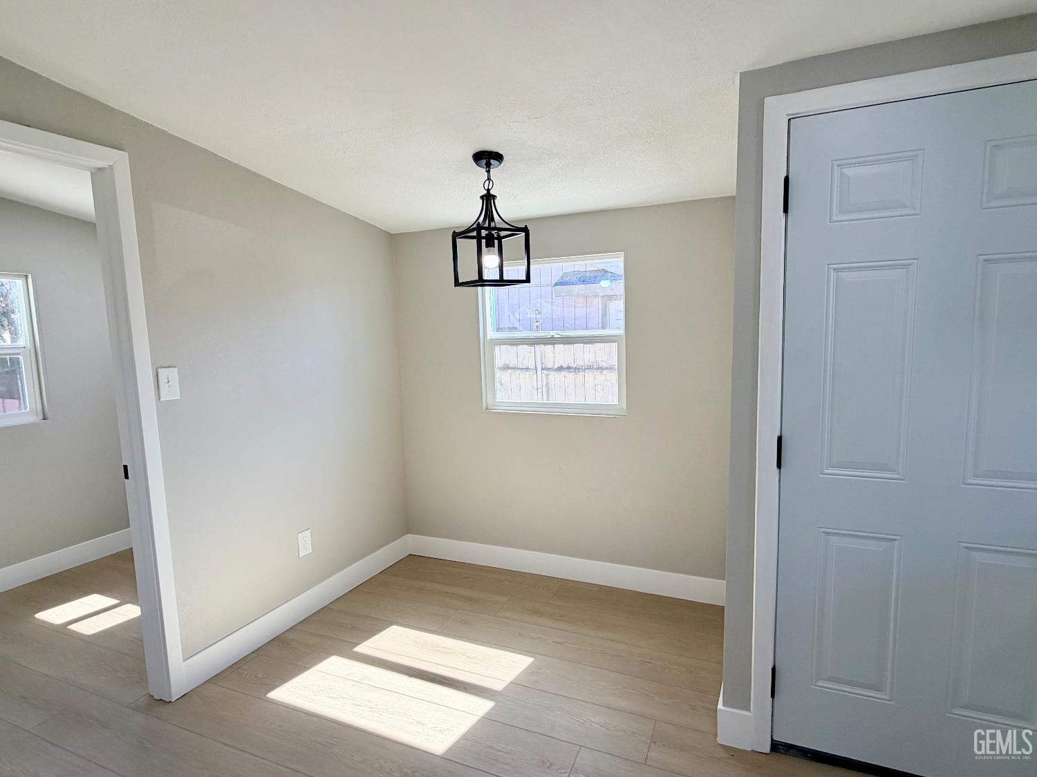 Undisclosed Address Wasco, CA 93280 - Photo 8 of 21 an empty room with windows and cabinet