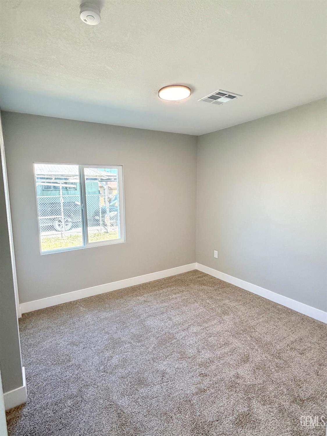 Undisclosed Address Wasco, CA 93280 - Photo 10 of 21 an empty room with windows