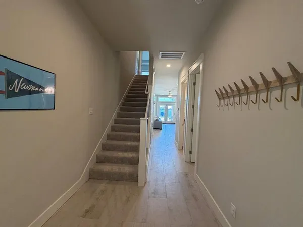 a living room with furniture and large windows