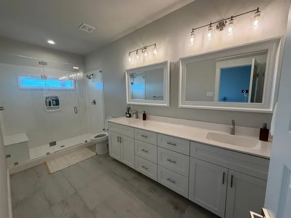 a bedroom with a large bed and a flat screen tv