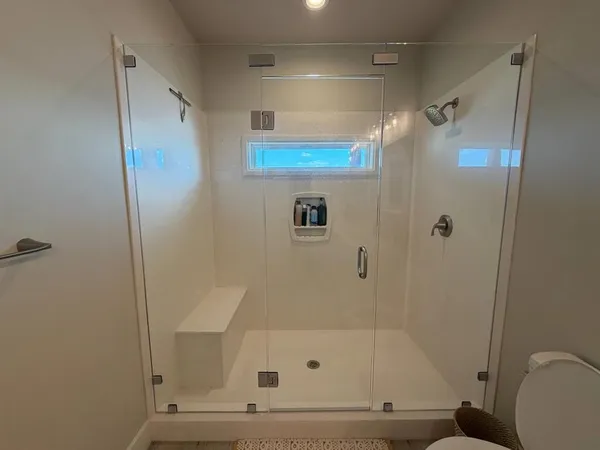 a spacious bathroom with double sink large mirror and a bathtub