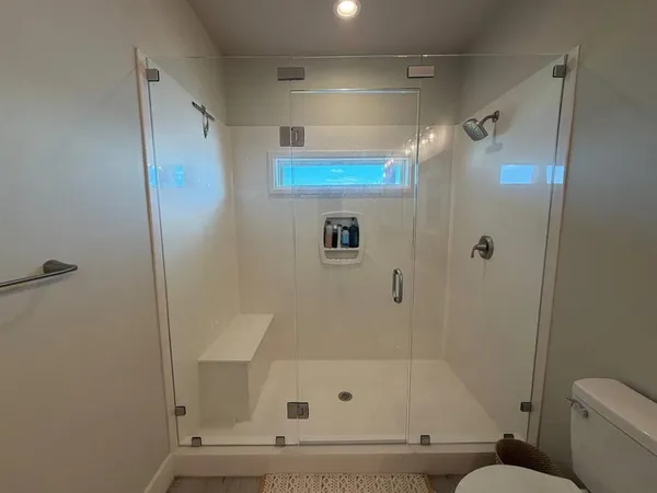 a spacious bathroom with double sink a large mirror and a