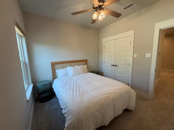 a spacious bathroom with a double vanity sink toilet mirror and bathtub