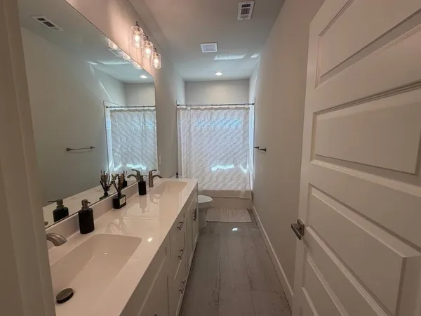 a bedroom with a large bed and a ceiling fan