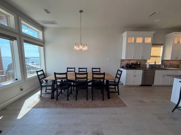 a large kitchen with a table and chairs