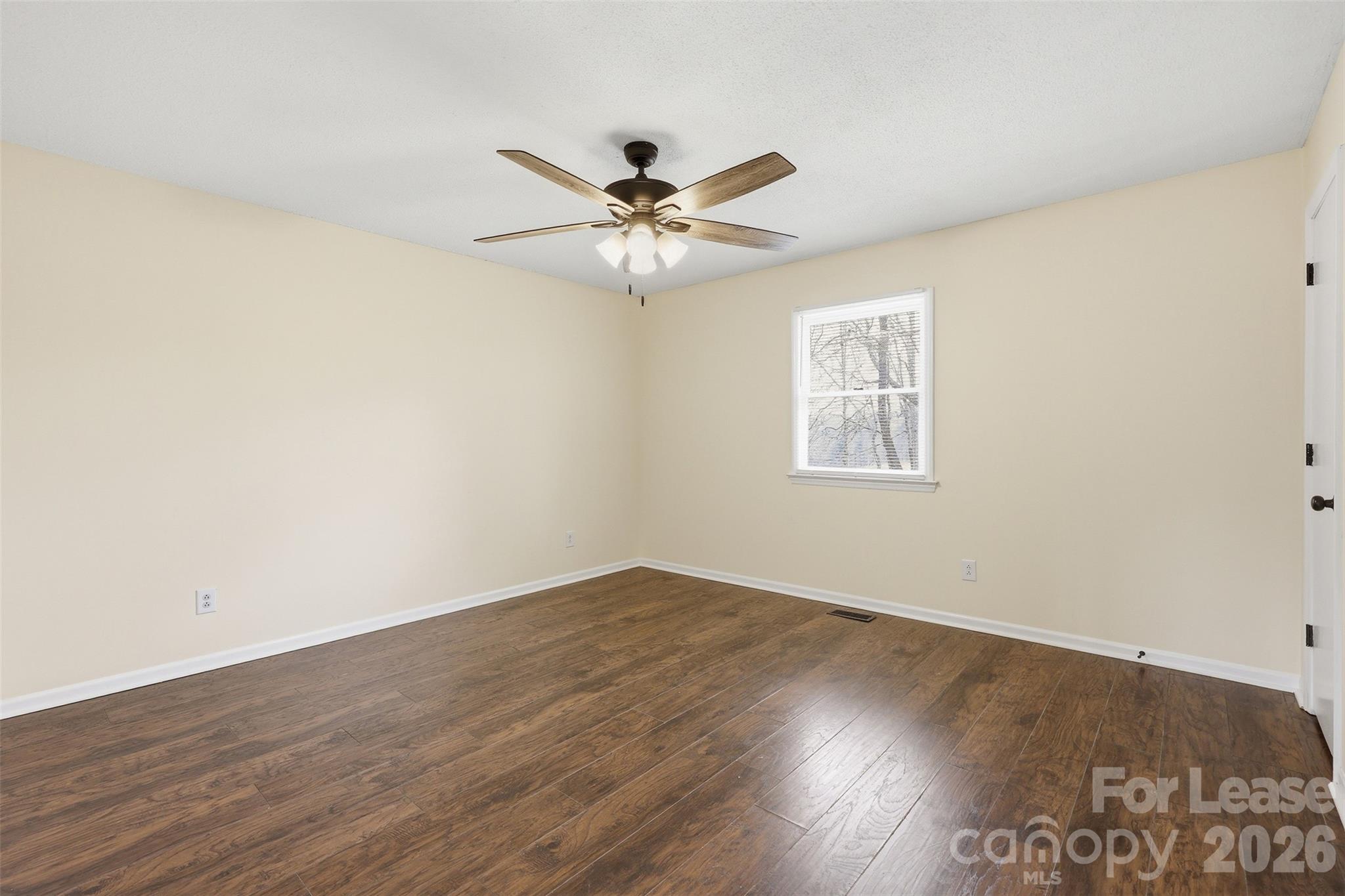 224 Yamasee Road Waxhaw, NC 28173 - Photo 12 of 22 an empty room with wooden floor and windows