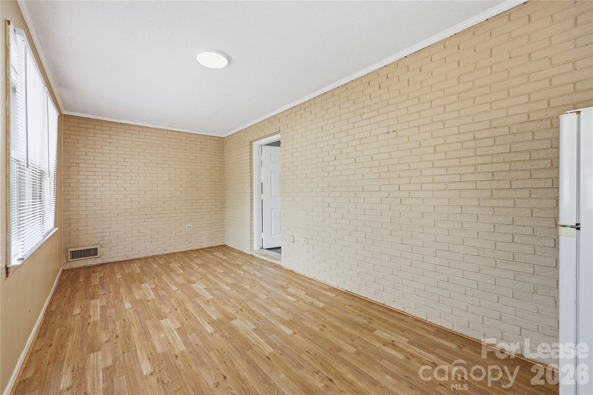 224 Yamasee Road Waxhaw, NC 28173 - Photo 13 of 22 a view of an empty room with wooden floor and a window