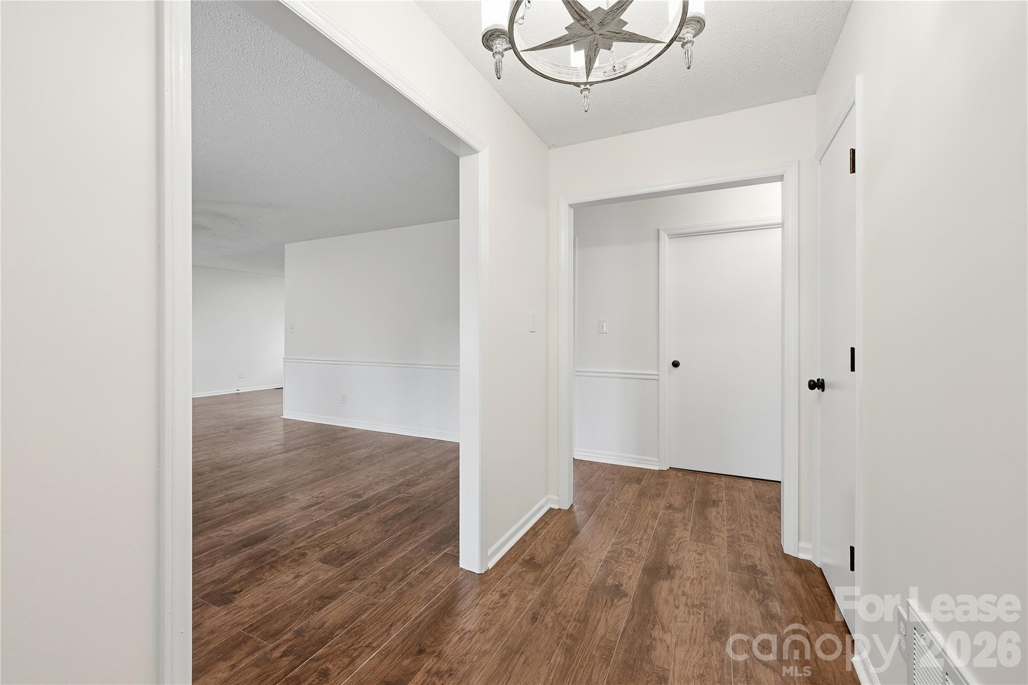 224 Yamasee Road Waxhaw, NC 28173 - Photo 2 of 22 a view of a room with wooden floor and white walls