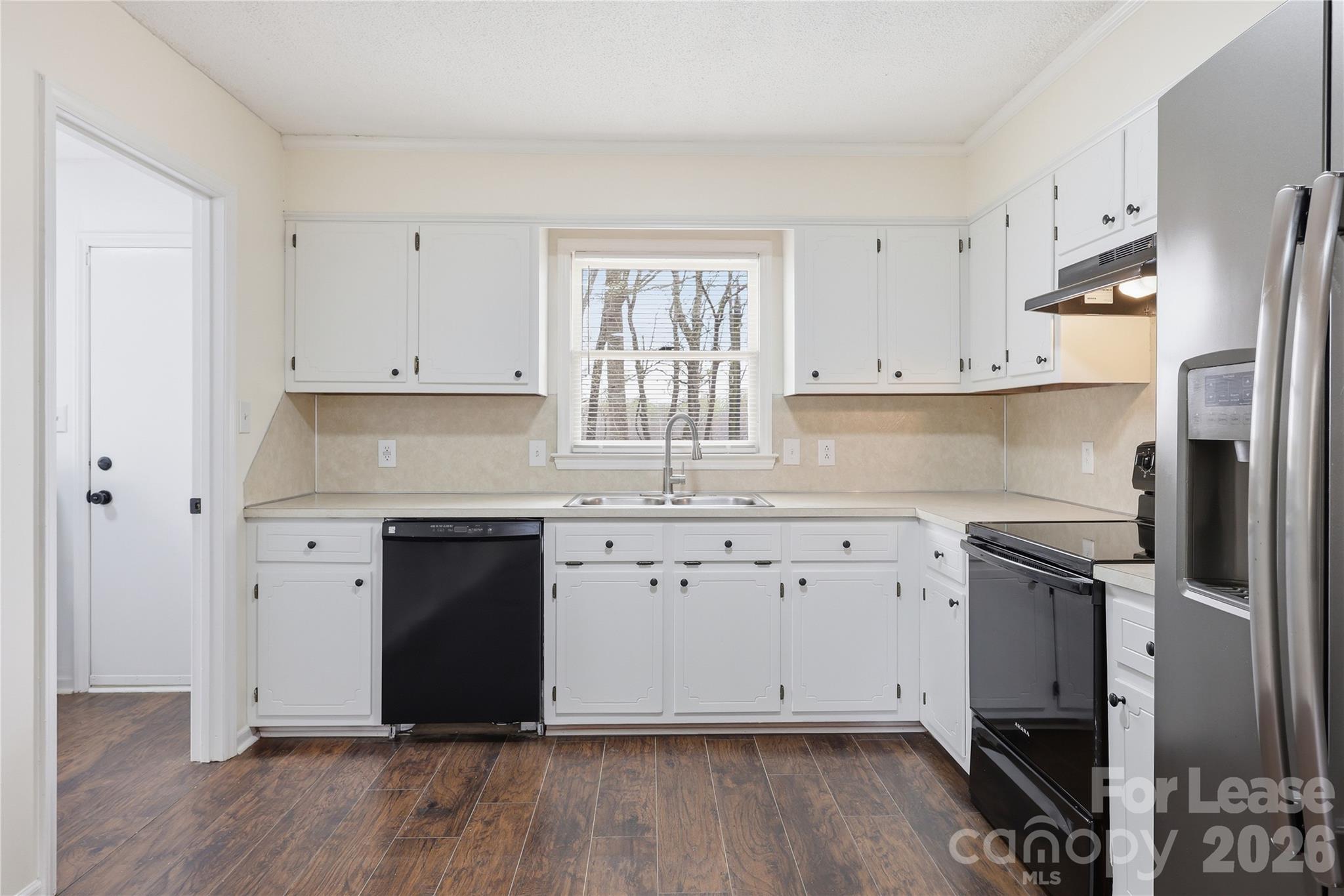 224 Yamasee Road Waxhaw, NC 28173 - Photo 5 of 22 a kitchen with granite countertop white cabinets and stainless steel appliances