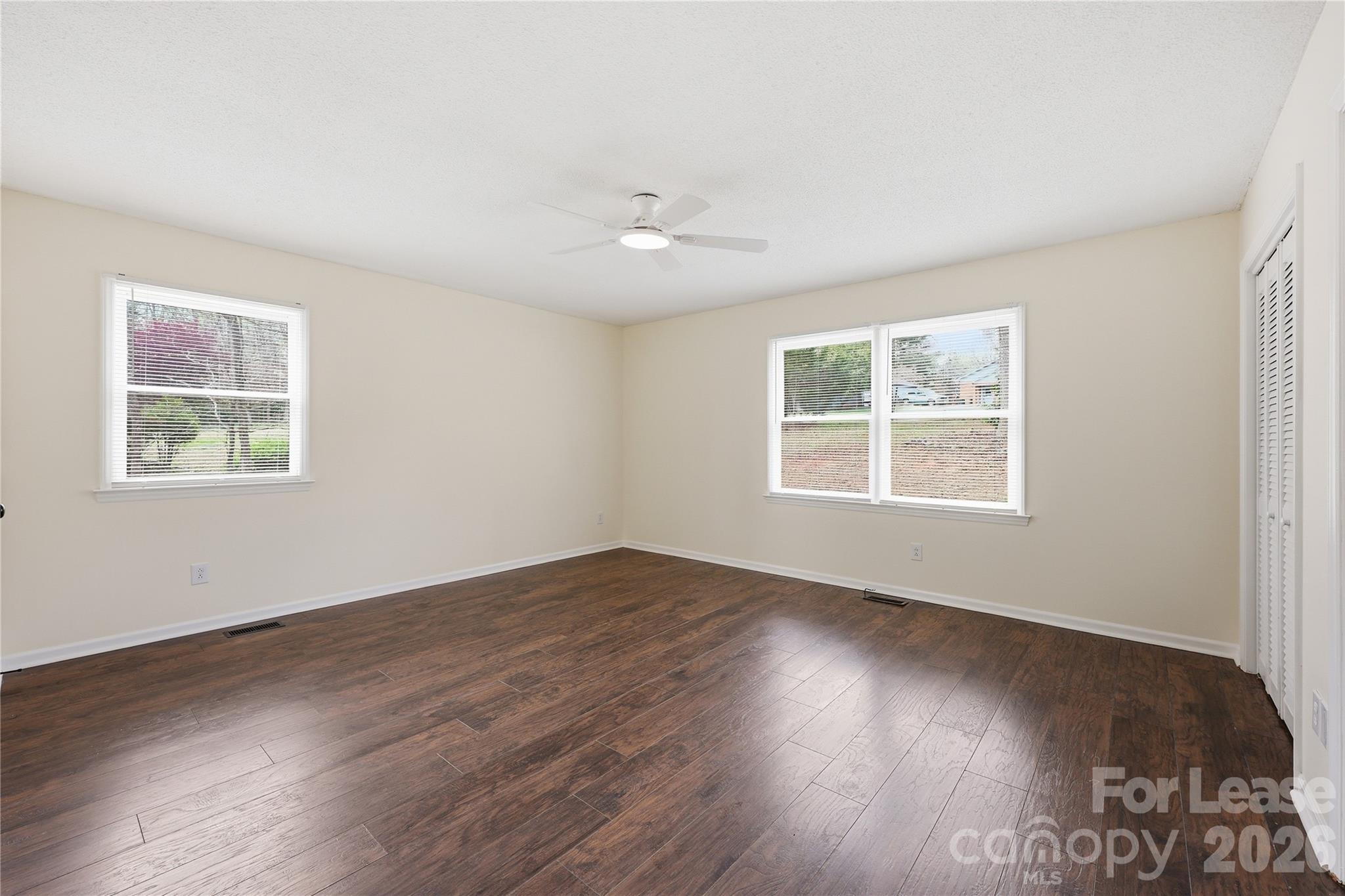 224 Yamasee Road Waxhaw, NC 28173 - Photo 6 of 22 a view of an empty room with wooden floor and a window