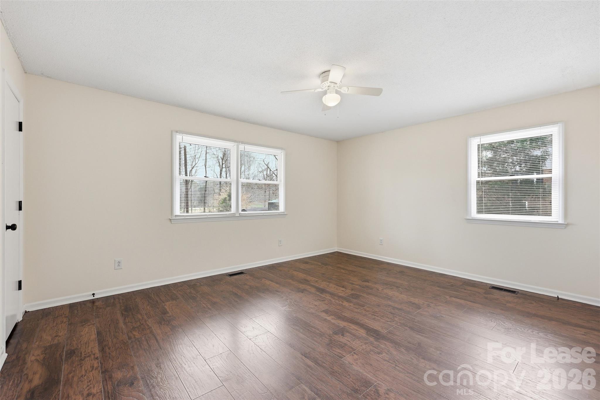 224 Yamasee Road Waxhaw, NC 28173 - Photo 8 of 22 a view of an empty room with wooden floor and a window