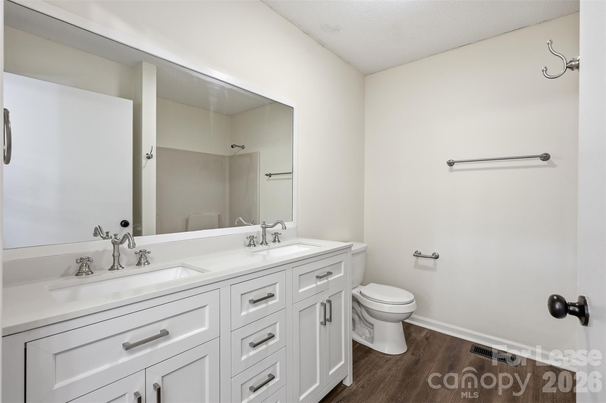 224 Yamasee Road Waxhaw, NC 28173 - Photo 10 of 22 a bathroom with a granite countertop sink a toilet and a mirror