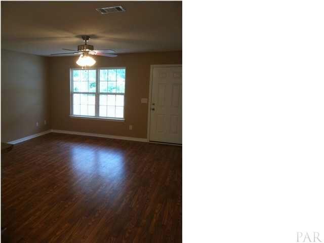 4680 Old Guernsey Road Pace, FL 32571 - Photo 4 of 6 a view of a livingroom with wooden floor and a window