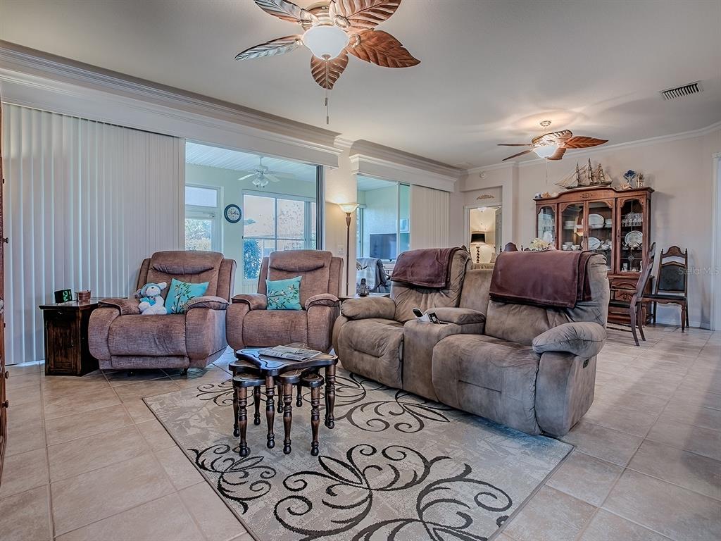 13324 Southeast 91st Court Road Summerfield, FL 34491 - Photo 14 of 46 a living room with furniture and a chandelier
