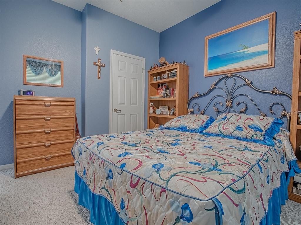 13324 Southeast 91st Court Road Summerfield, FL 34491 - Photo 19 of 46 a bedroom with a bed and a dresser