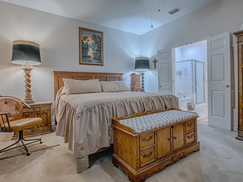 13324 Southeast 91st Court Road Summerfield, FL 34491 - Photo 21 of 46 a bedroom with a bed and a tv