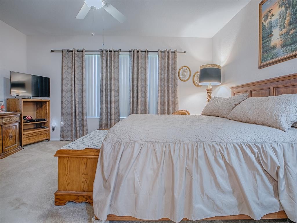 13324 Southeast 91st Court Road Summerfield, FL 34491 - Photo 23 of 46 a bedroom with a bed and a television in it