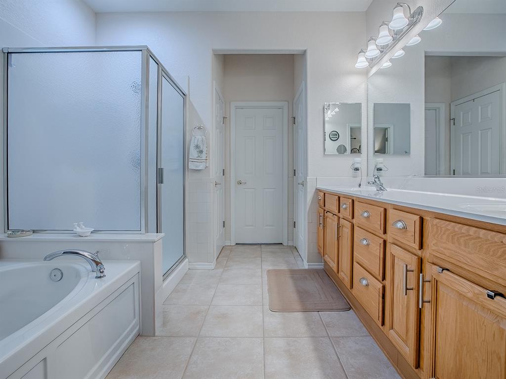 13324 Southeast 91st Court Road Summerfield, FL 34491 - Photo 24 of 46 a bathroom with a tub sink shower and mirror