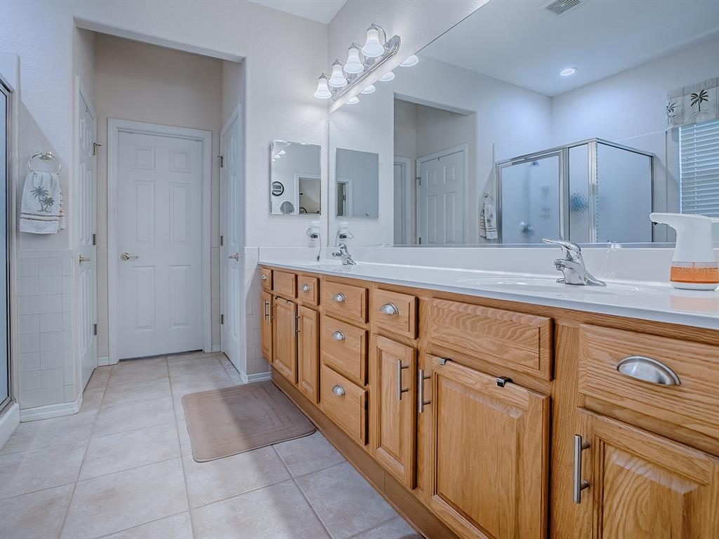 13324 Southeast 91st Court Road Summerfield, FL 34491 - Photo 25 of 46 a spacious bathroom with a double vanity sink a mirror and a