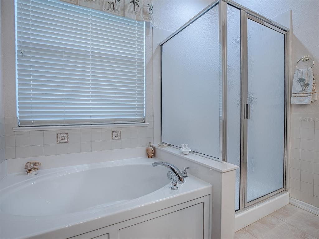 13324 Southeast 91st Court Road Summerfield, FL 34491 - Photo 26 of 46 a bathroom with a tub and a shower