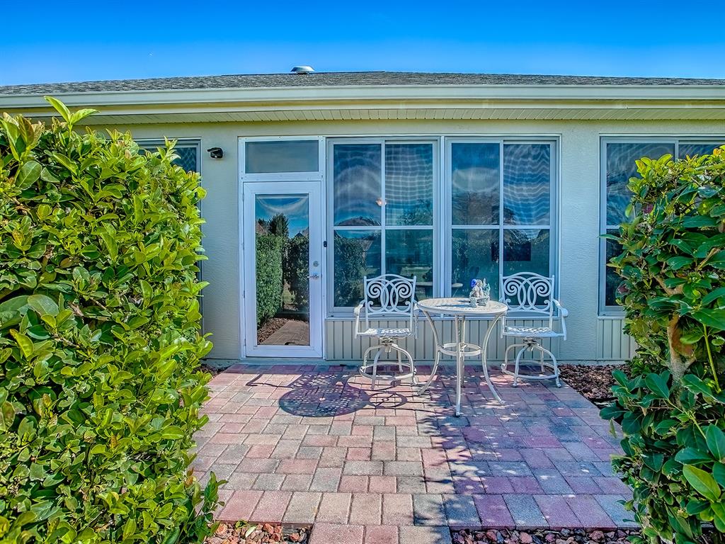13324 Southeast 91st Court Road Summerfield, FL 34491 - Photo 36 of 46 a front view of a house with garden and porch