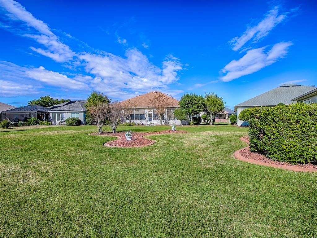 13324 Southeast 91st Court Road Summerfield, FL 34491 - Photo 37 of 46 a view of yard with swimming pool and green space