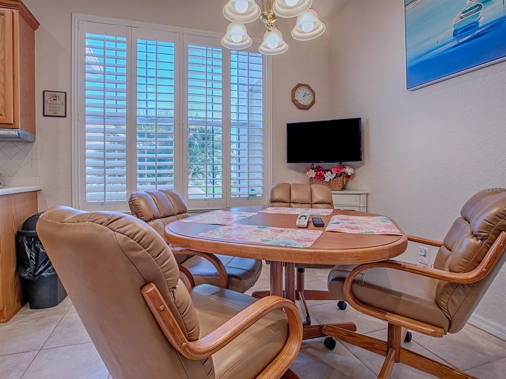 13324 Southeast 91st Court Road Summerfield, FL 34491 - Photo 5 of 46 a bedroom with a bed and a flat screen tv