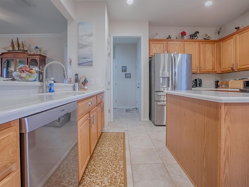 13324 Southeast 91st Court Road Summerfield, FL 34491 - Photo 6 of 46 a kitchen with stainless steel appliances a sink and a refrigerator