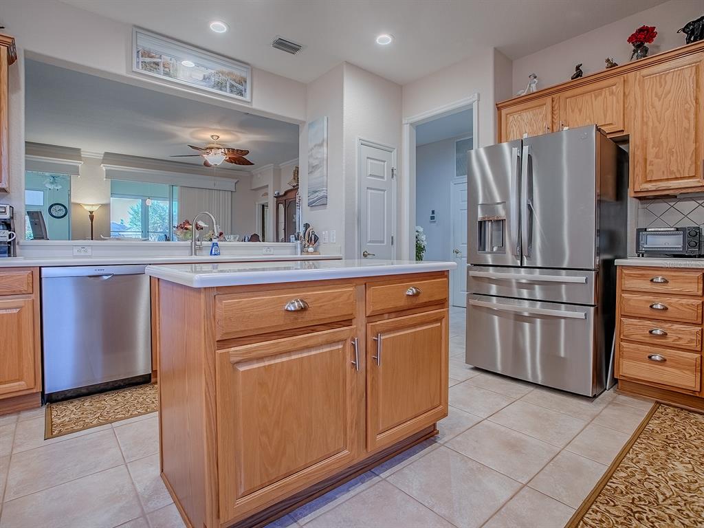 13324 Southeast 91st Court Road Summerfield, FL 34491 - Photo 7 of 46 a kitchen with kitchen island granite countertop cabinets and stainless steel appliances