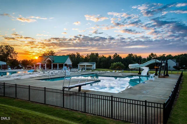 a view of a swimming pool and lounge chairs