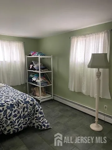 a view of a livingroom with wooden floor and windows