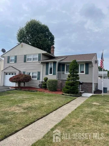 a front view of a house with a yard porch and outdoor seating