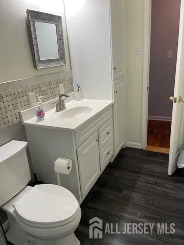 a bathroom with a toilet and a shower curtain