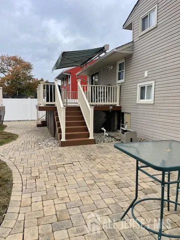 a backyard of a house with table and chairs
