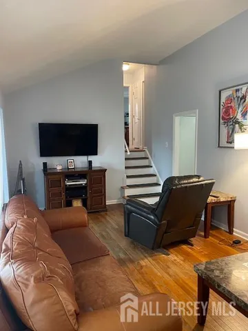 a view of a dining room with furniture wooden floor and chandelier