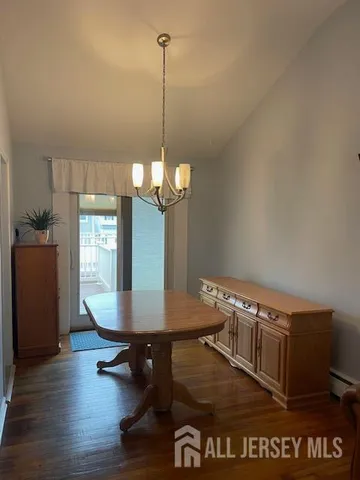 a view of a room with a window and wooden floor