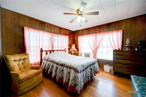 a spacious bedroom with a bed and a chandelier