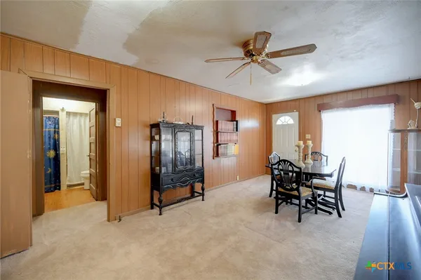 a dining room with furniture and window