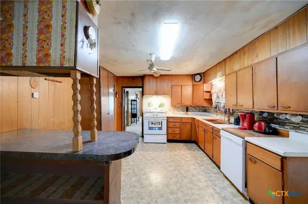 a kitchen with stainless steel appliances kitchen island granite countertop a sink and cabinets