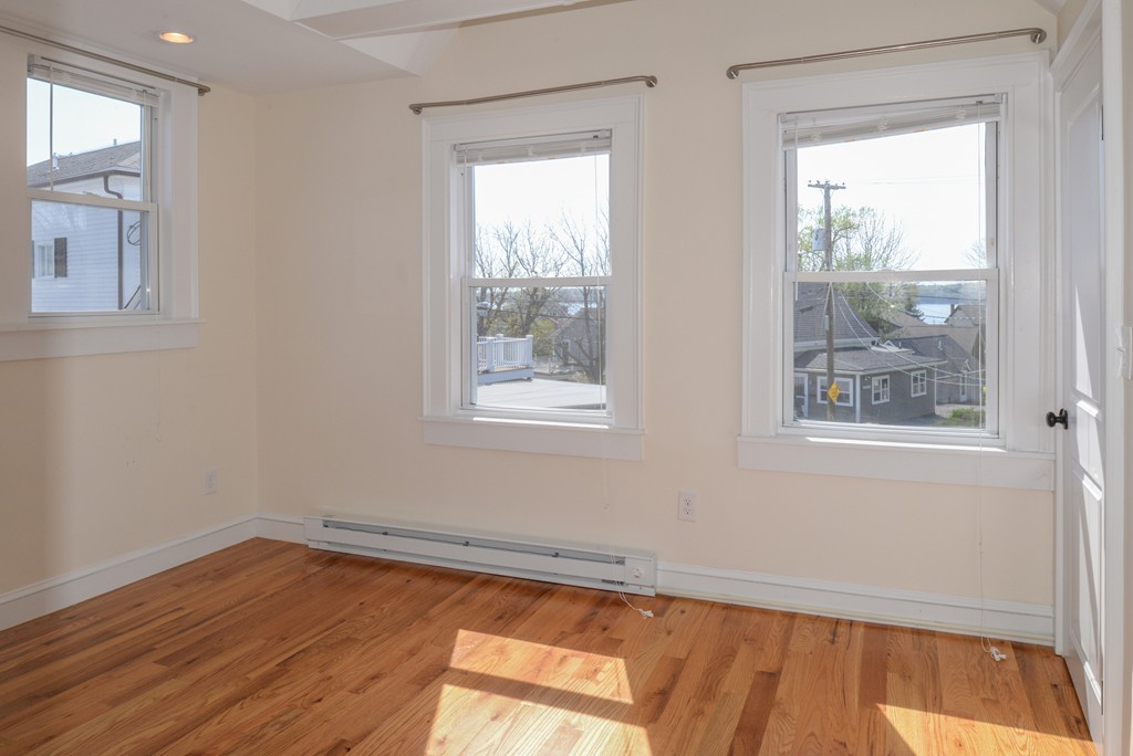 62 Eastern Point Road, Unit 1 Gloucester, MA 01930 - Photo 15 of 20 a view of a room with wooden floor and windows